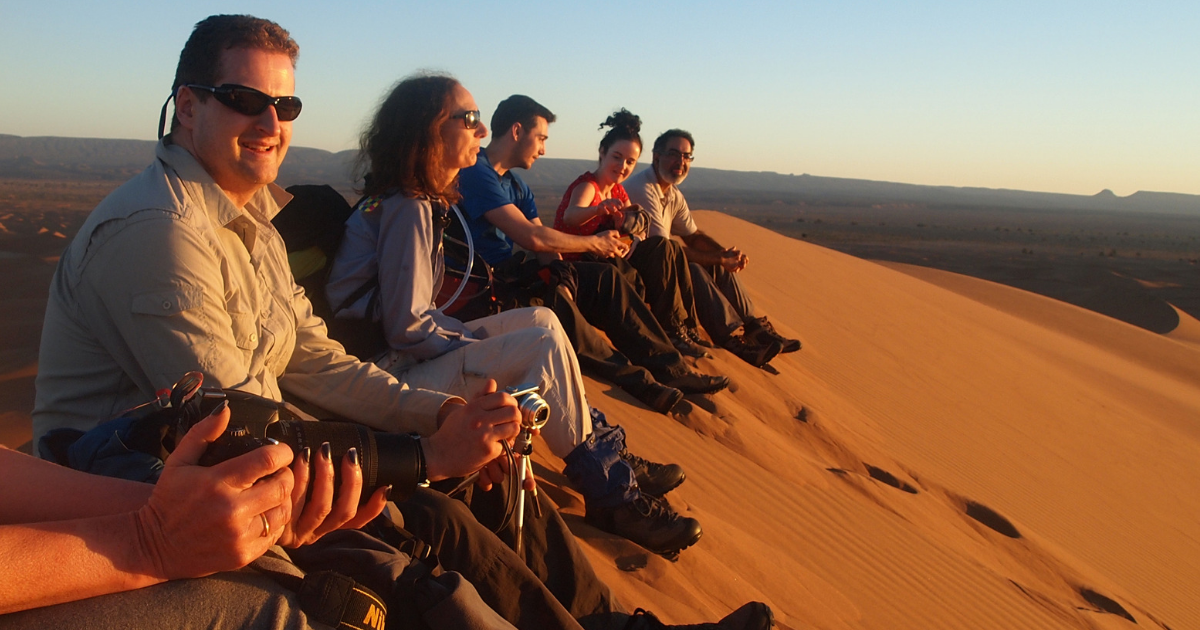 People look out over the Sahara Desert